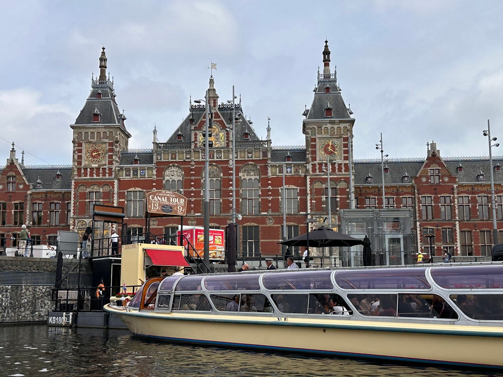 Canal tour boat in front of Amsterdam Centraal